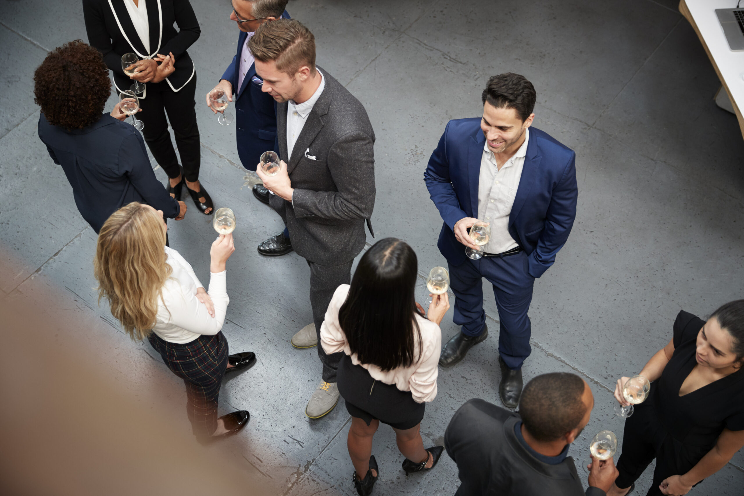 Professionals networking over drinks at a corporate event.